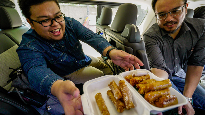 photo of people eating in a car